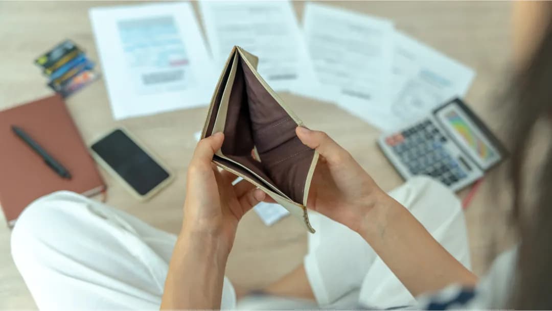 A person researching tax deductions online, with a calculator and paperwork. Text: "Saving money on taxes with bad credit loan."
