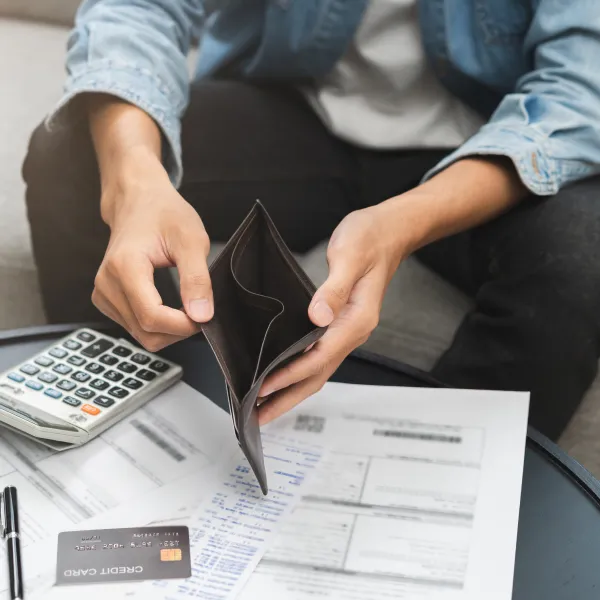 A person filling out a tax form with a calculator and money, with the text "Fast loan" in the background.
